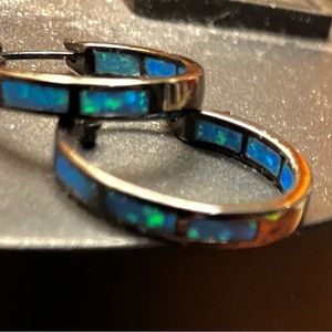 Austrian opal bright blue crystal set into a black silver hoop w latch clip